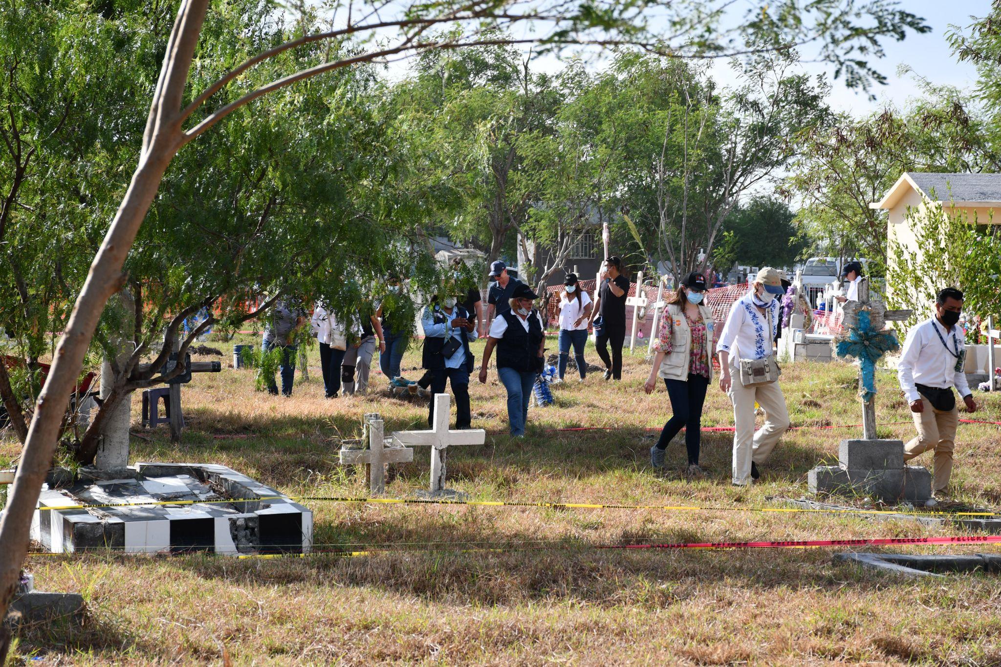 People are walking over a graveyard.
