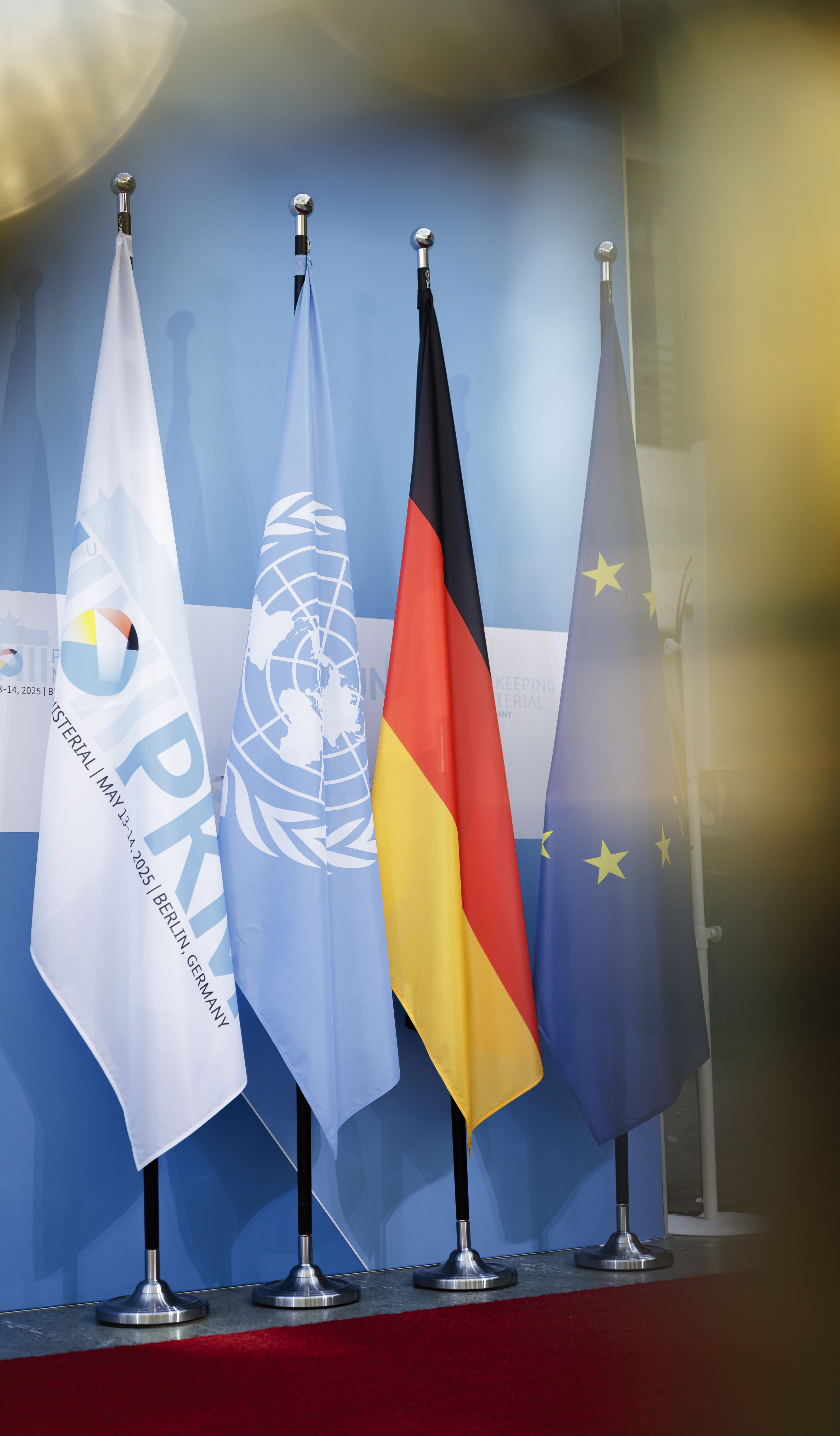 UN Peacekeeping Ministerial 2025. Berlin, 13.05.2025. The PKM flag next to the UN and Germany flag.